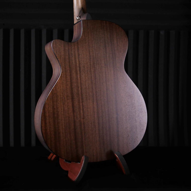 Back view of a brown wood acoustic guitar on a stand against a dark striped background, highlighting the wood grain and curved body edge. ขายราคาพิเศษ