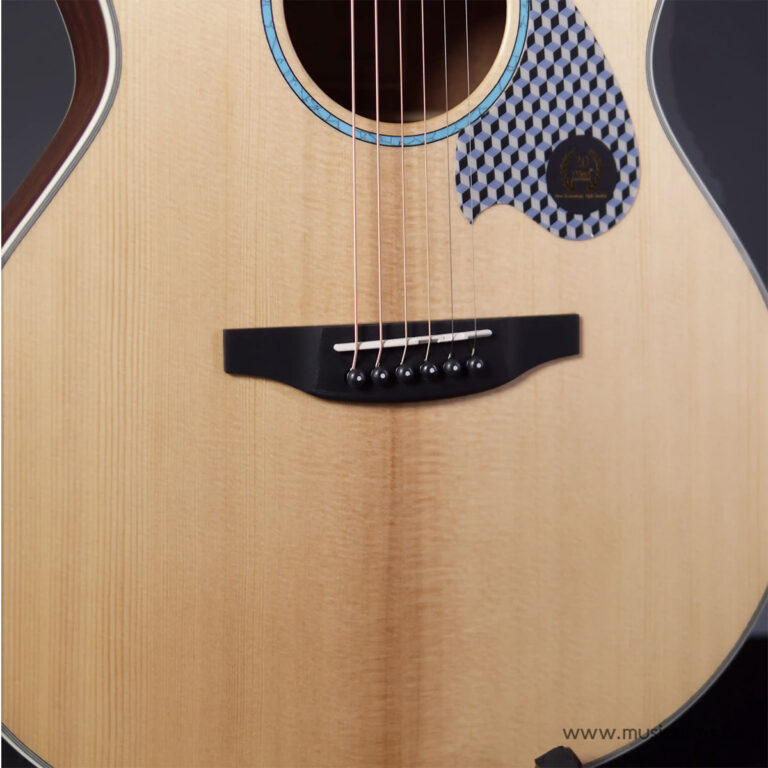 Close-up of an acoustic guitar body showing six strings over the bridge and soundhole, with a patterned pickguard nearby. ขายราคาพิเศษ
