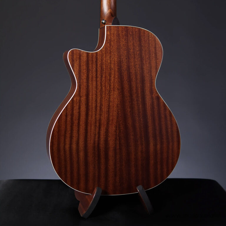 Back of a polished mahogany acoustic guitar with striped grain and white binding on a stand. ขายราคาพิเศษ